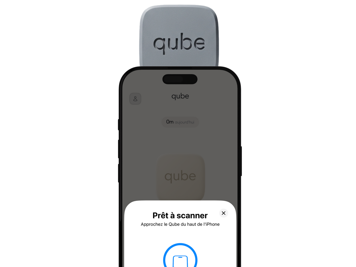 An iPhone with the Qube resting on top of it